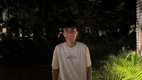 Santi Monjo smiling outdoors at night.